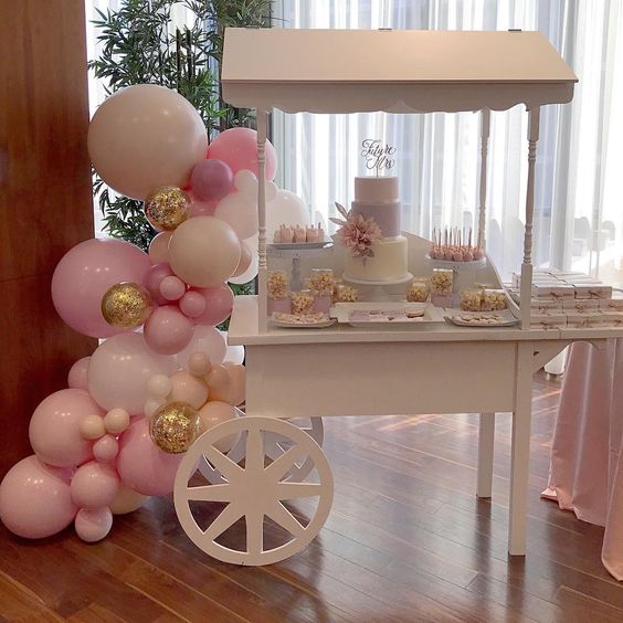 White Candy Cart with cakes & pink balloons