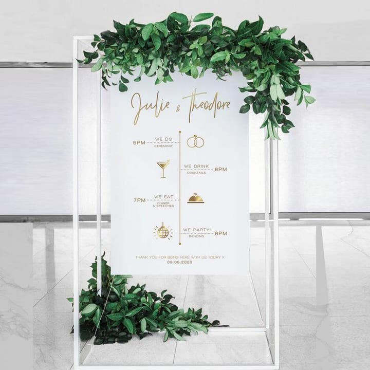 Order of The Day Sign Julie & Theodore on white frame with greenery