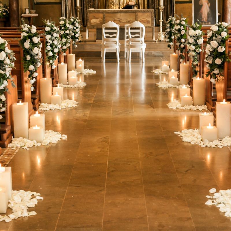 wedding ceremony aisle with white candles & petals on the floor
