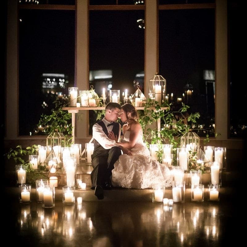 bride and groom in front of candles