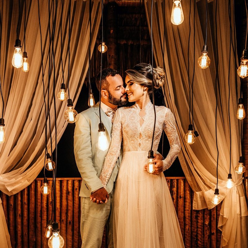 bride and groom in front of hanging light